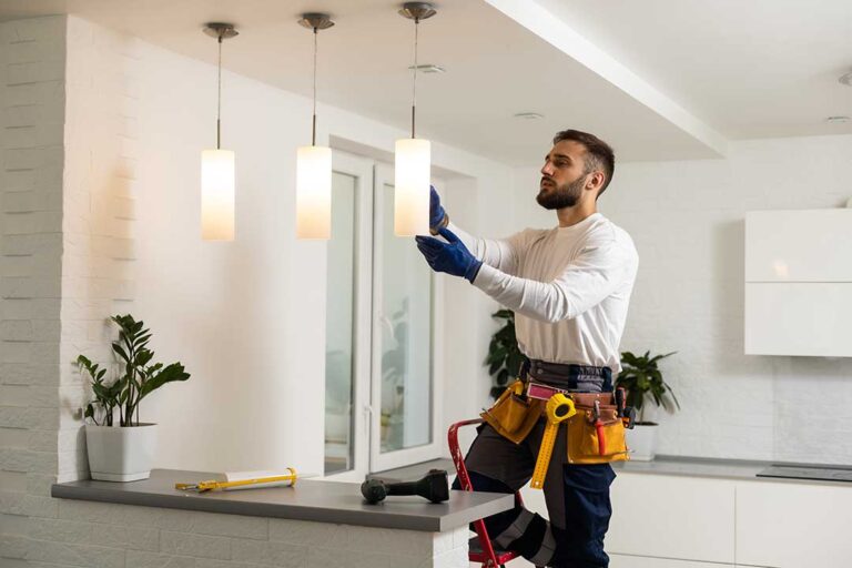 An electrician inspects a standard home electrical breaker panel with switches in the ON and OFF positions.